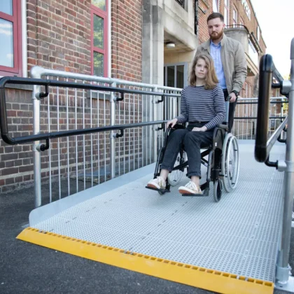 a man helping a girl on a wheel chair