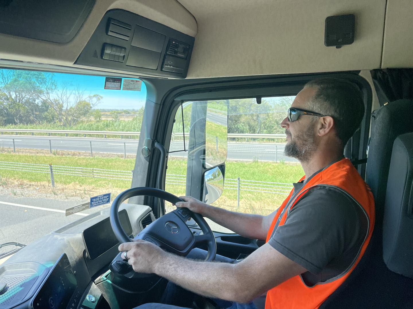 a man driving a truck happily