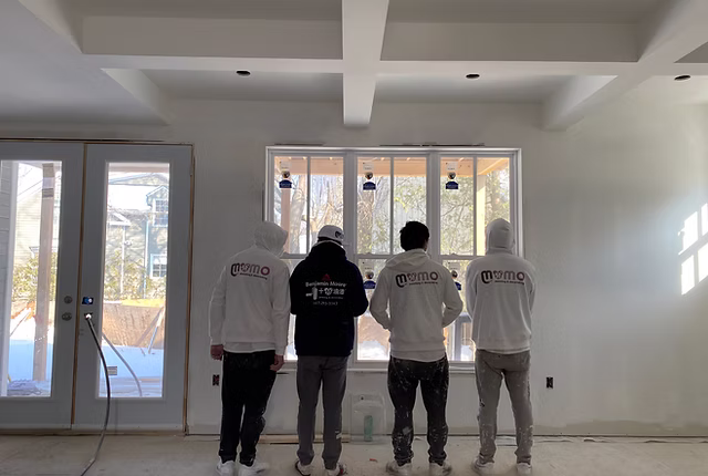 four guys after finishing their painting jobs