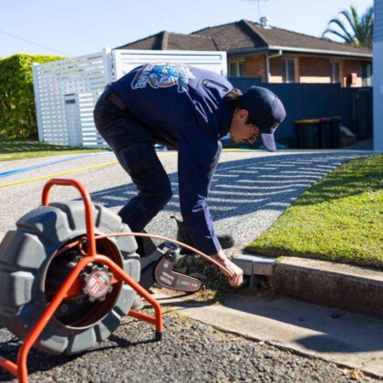 a man draining and clearing blocked stormwater