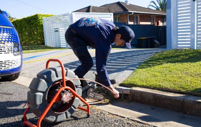 a man draining and clearing blocked stormwater