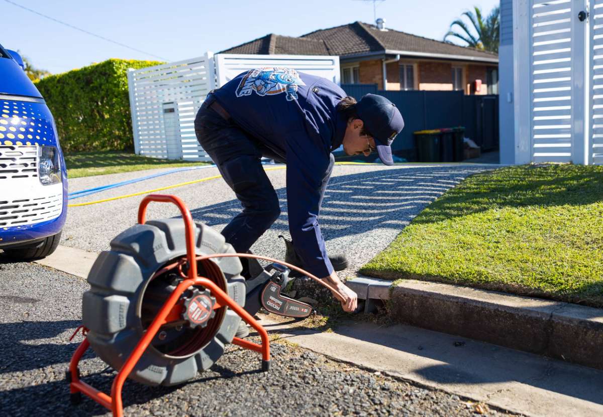 a man draining and clearing blocked stormwater