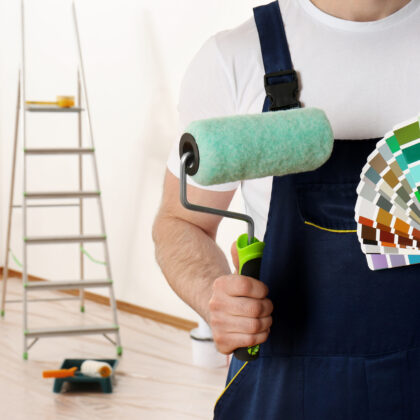 a man with a paint brush and a palette of colors of his painting business